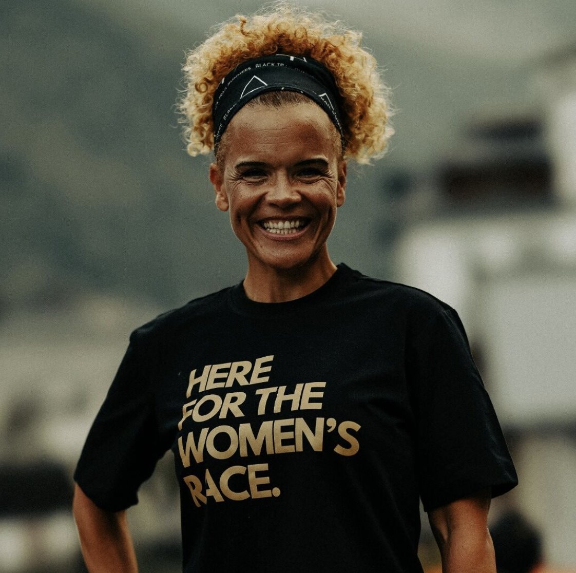 Sabrina Pace-Humphreys smiling in a 'Here for the Women's Race' Black Trail Runners tee