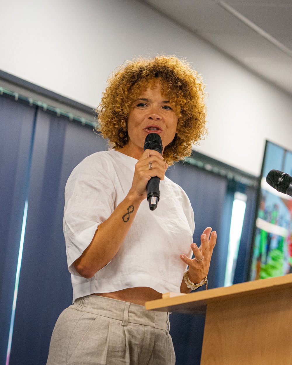 Sabrina Pace-Humphreys speaking into a microphone at a podium